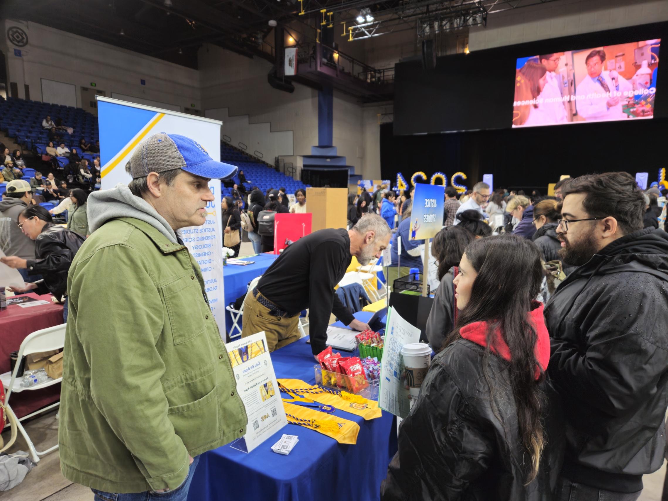 Professor Harold Peterson speaking with students at Department of Justice Studies Booth during Admitted Spartan Day on 4/13/2024.