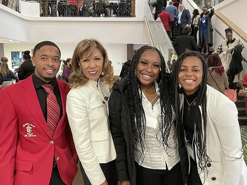 President Teniente-Matson posing with students.