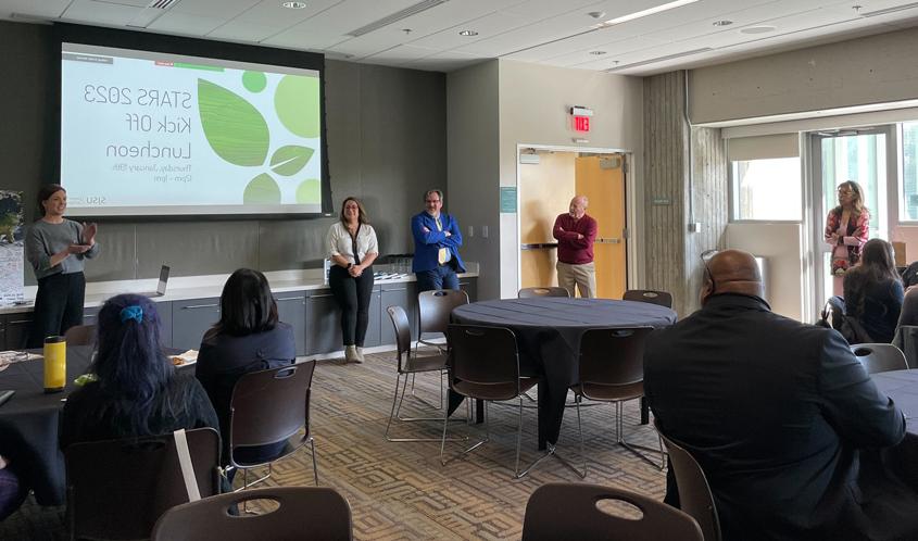 Office of Sustainability giving a presentation in a conferenece room.