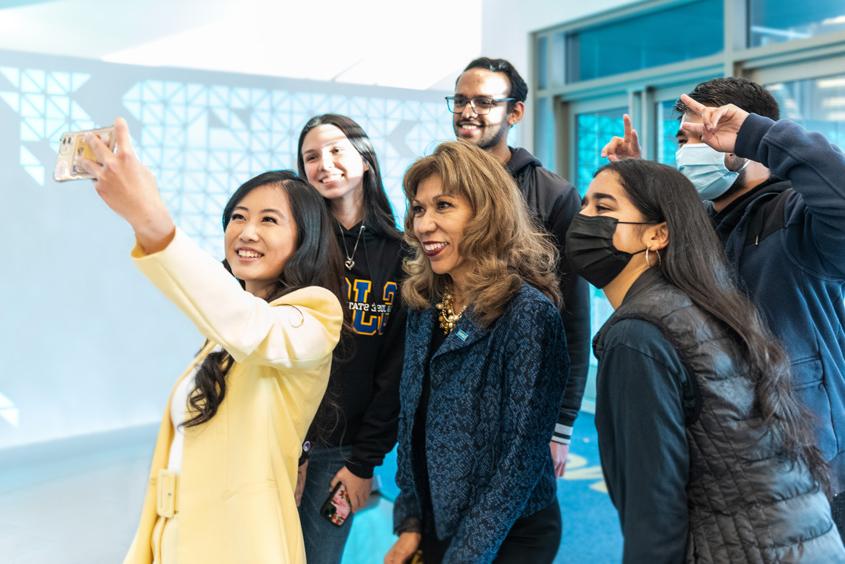 President Teniente-Matson taking a selfie with students.