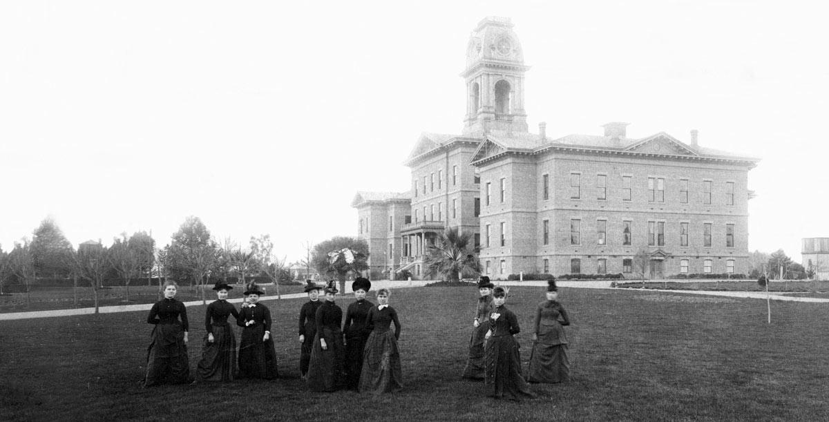 Historical image of female students in front of the Normal School.